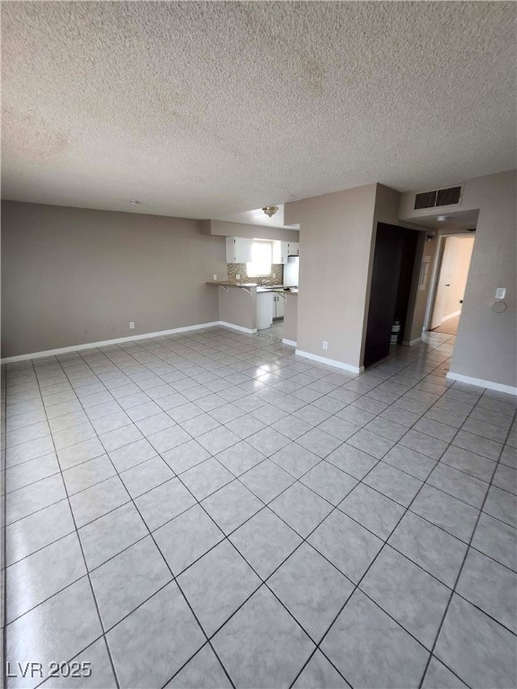 Unfurnished living room with light tile patterned