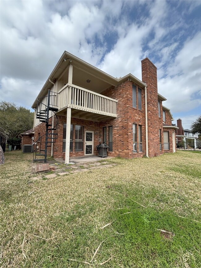 Backside of home with balcony