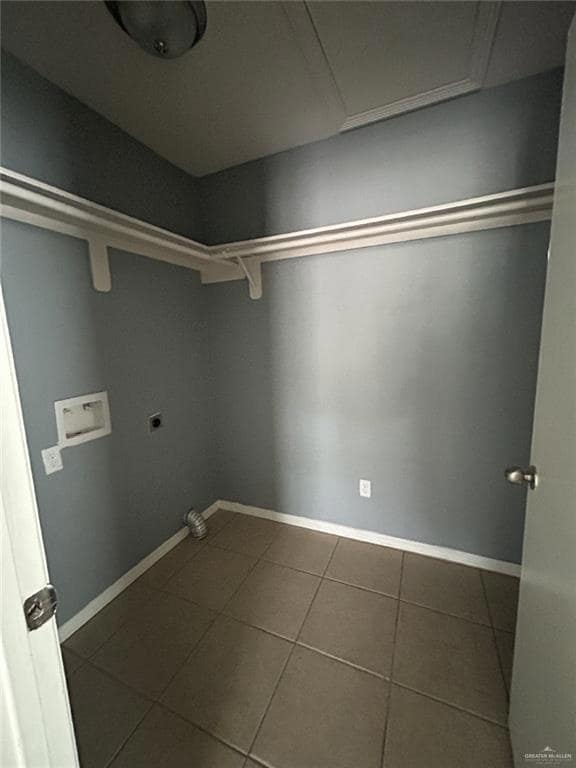 Laundry room featuring hookup for an electric dryer, hookup for a washing machine, tile patterned floors, and baseboards