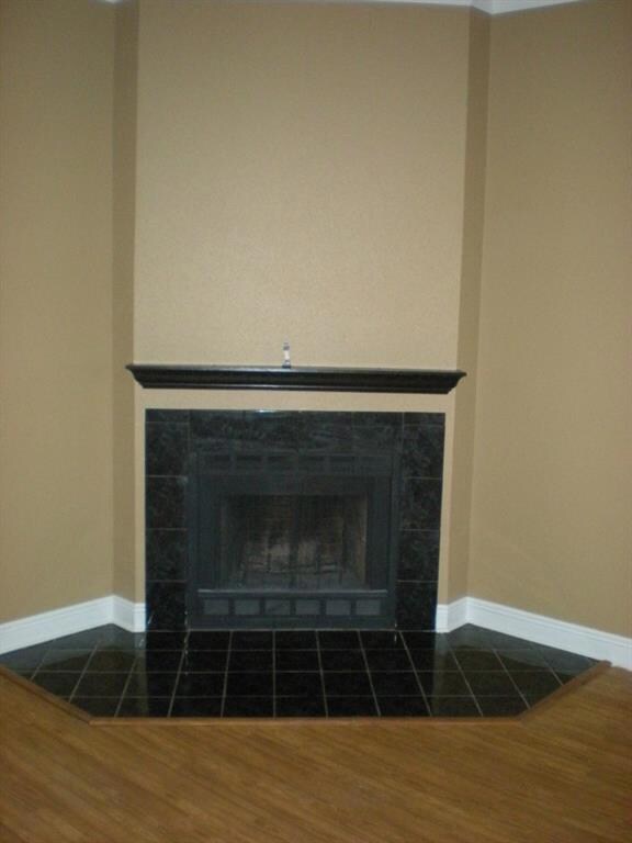 Corner wood burning fireplace.