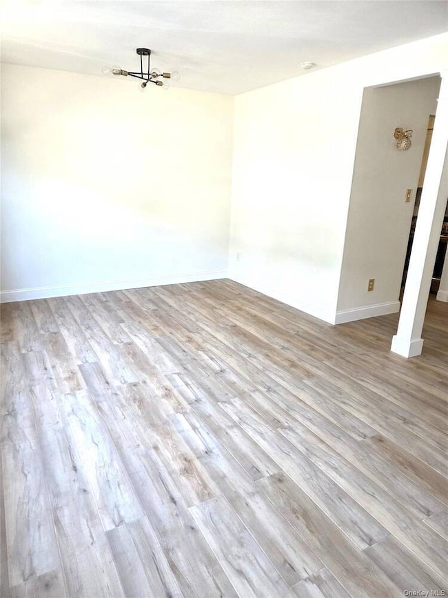 Spare room with light wood-type flooring