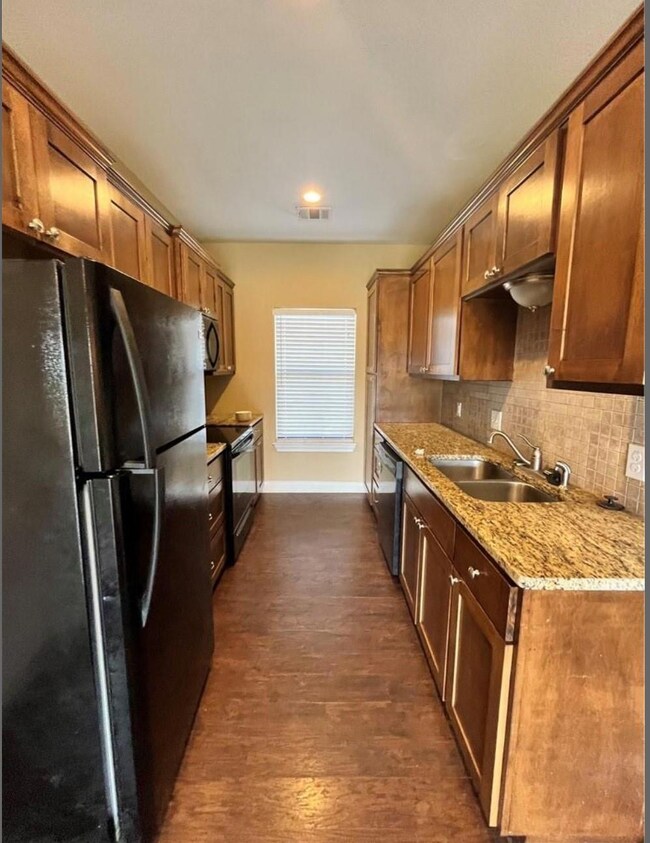 Kitchen featuring black appliances, decorative ba