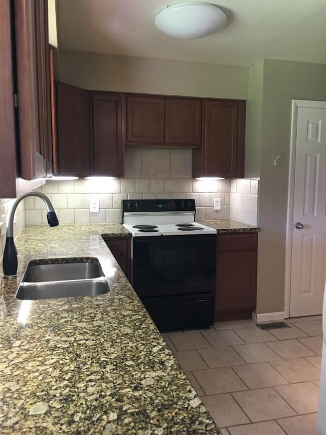 Stove/oven remains. Tile floor.