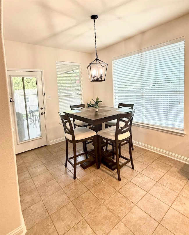 Dining area with light tile patterned floors