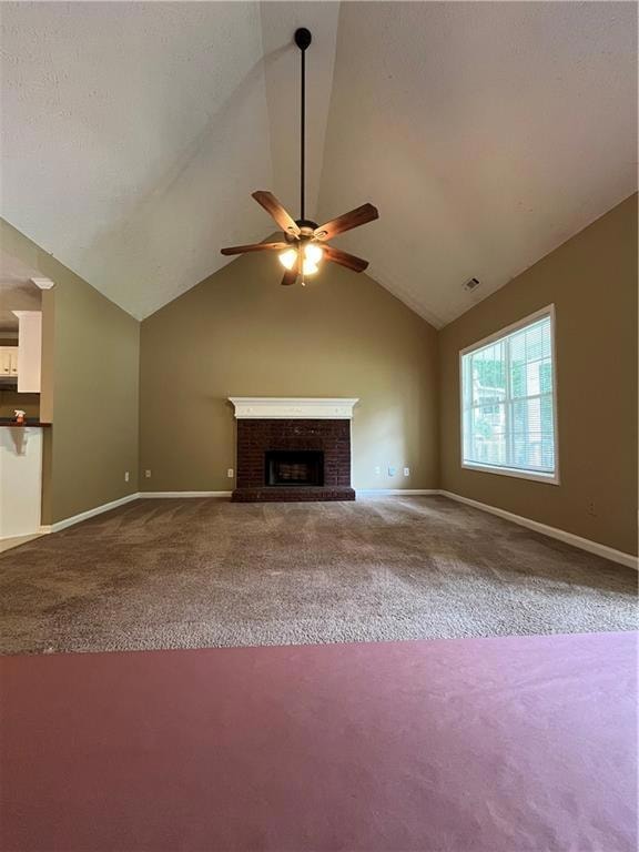 Unfurnished living room featuring carpet floors, a ceiling fan, baseboards, and lofted ceiling