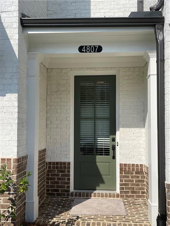 Entrance to property with brick siding