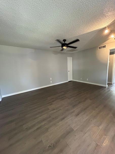 Empty room featuring dark wood-style flooring, a 