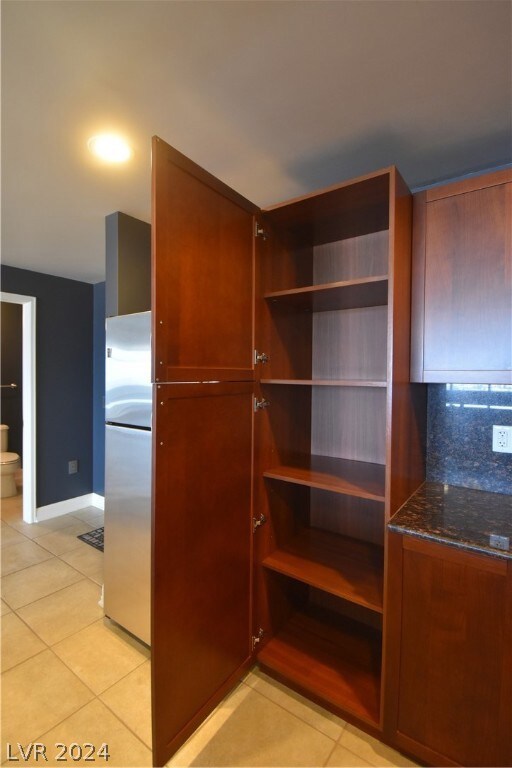 Kitchen pantry next to refrigerator