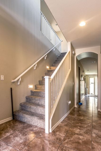 stairwell, upgraded tile downstairs