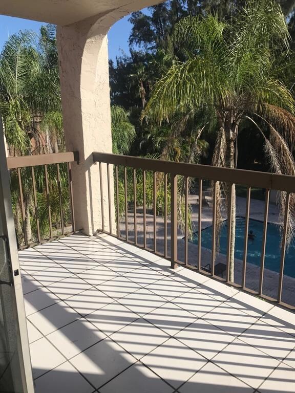 LOVELY OPEN BALCONY OVERLOOKING COMMUNITY POOL!