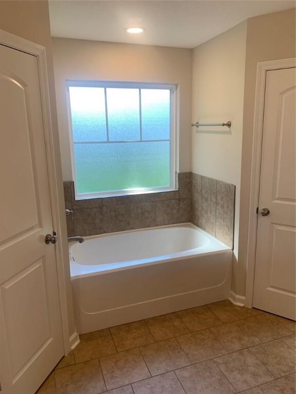 Separate Soaking Tub with Tiled Surround in Master