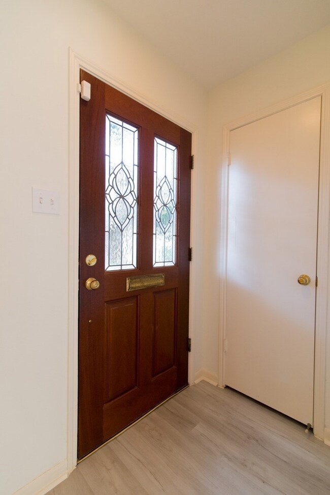 The foyer with a coat closet and new flooring as y