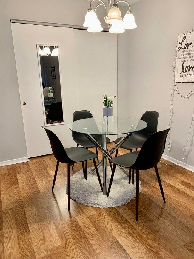 Dining area with a chandelier and hardwood / wood-