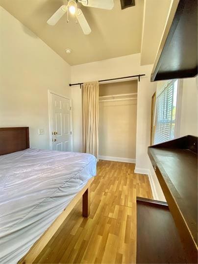 Bedroom featuring light wood finished floors, ceiling fan, and a closet