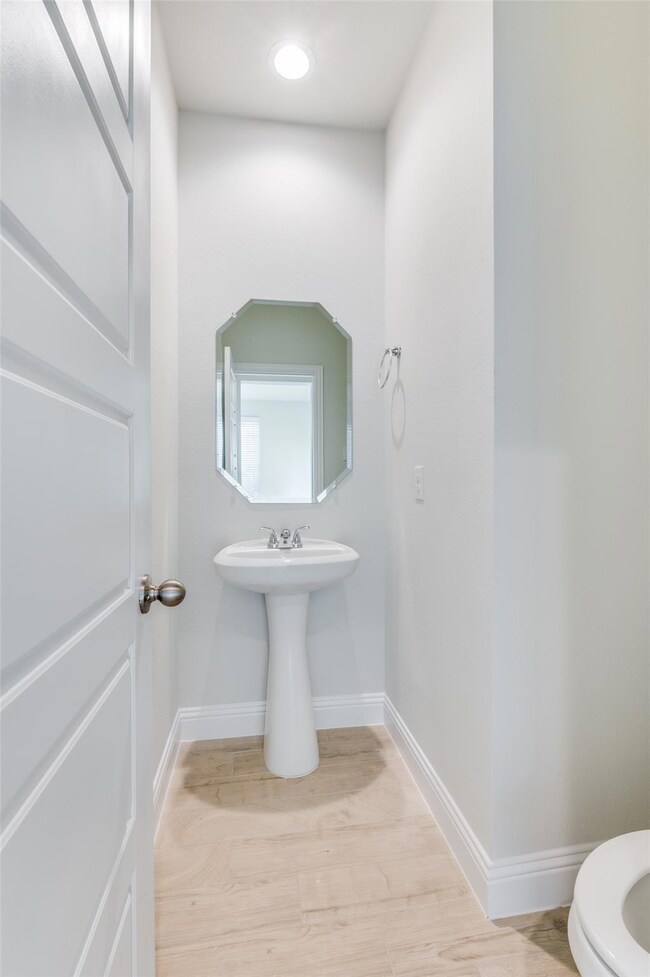 Bathroom with hardwood / wood-style flooring