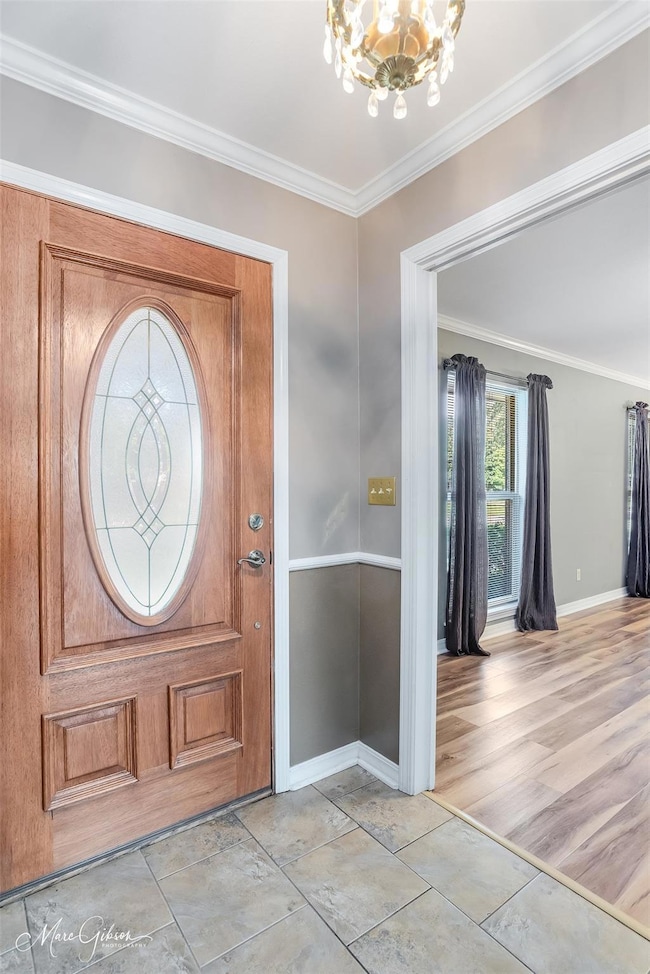 Entryway featuring ornamental molding, an inviting