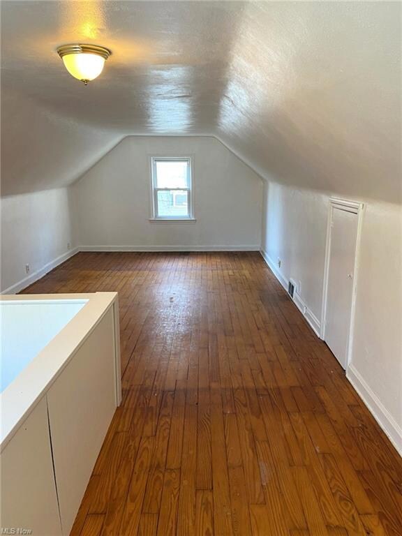 Second floor bedroom with wood floors.