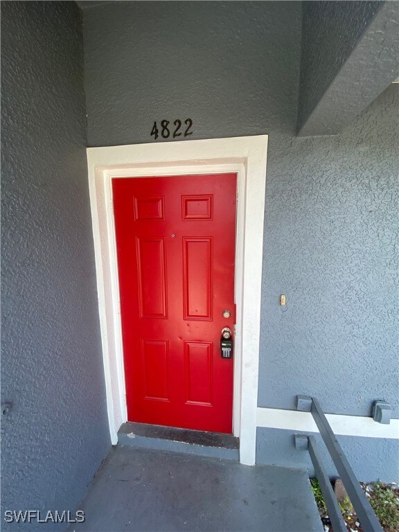 Property entrance with stucco siding