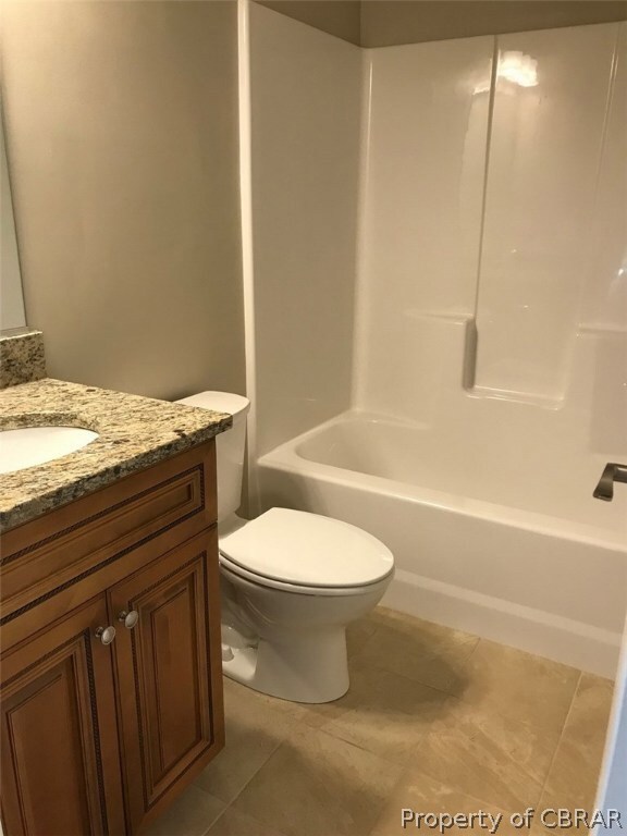 Guest bath with tile floor and Granite counter.