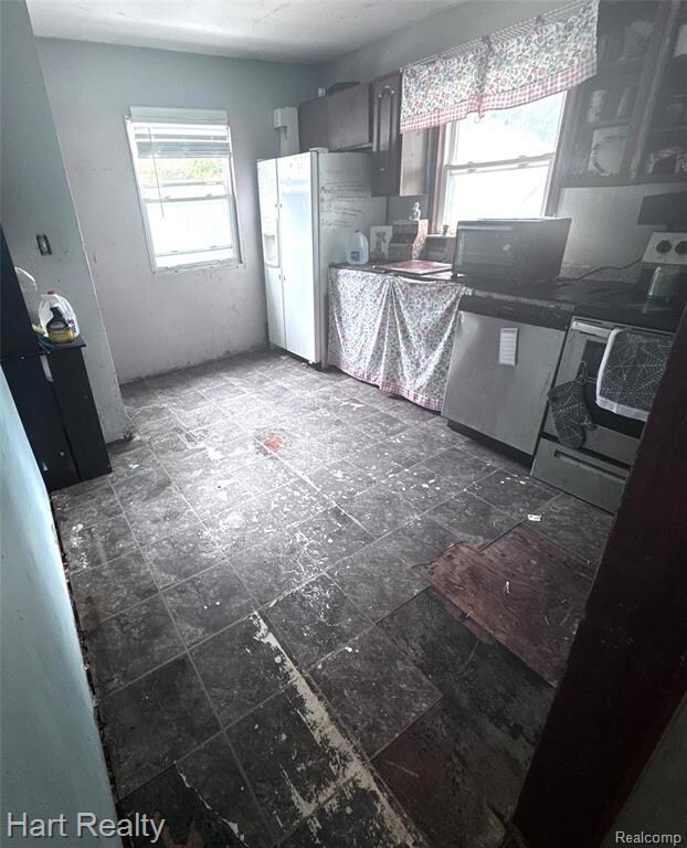 Kitchen with healthy amount of natural light and stainless steel appliances