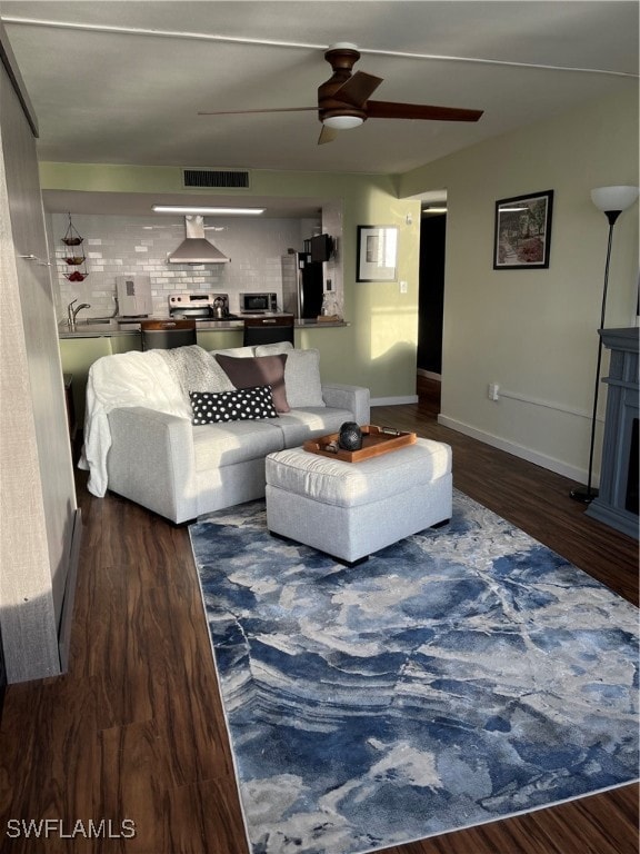Living room with ceiling fan and wood finished flo