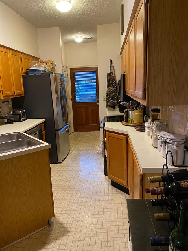 Kitchen featuring a textured ceiling, sink, tastef