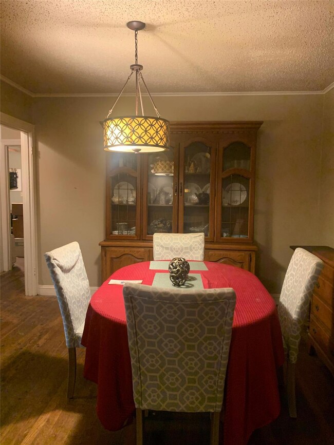Dining space featuring ornamental molding, a textu