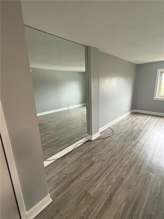 Spare room with wood finished floors and baseboards