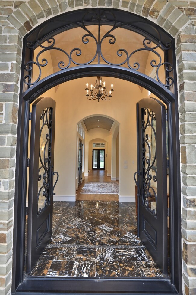 Stunning double Durango doors set the tone for many details found in this home