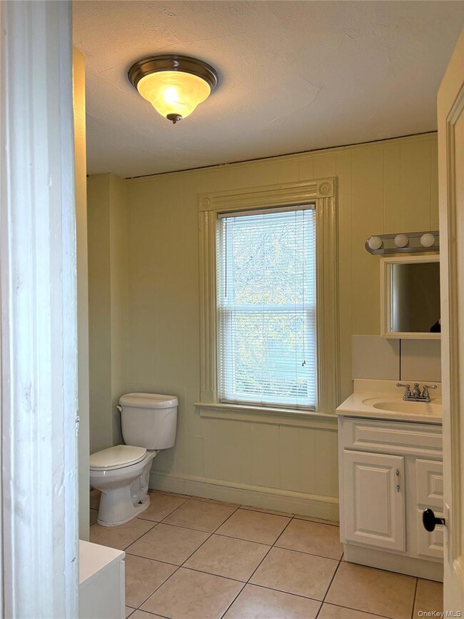 Bathroom with vanity and light tile patterned flooring