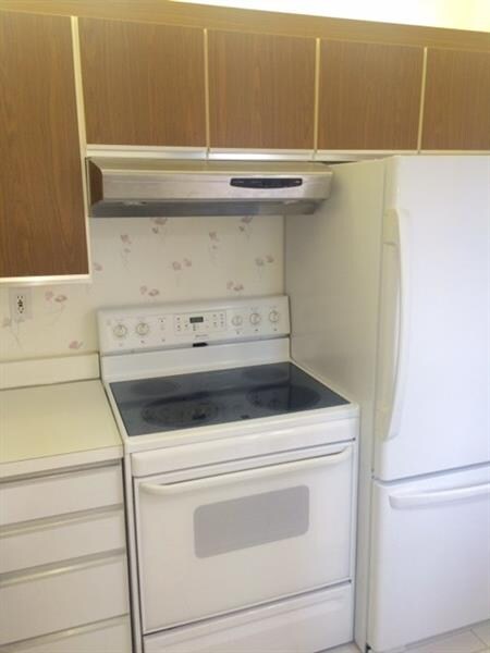 Well equipped kitchen with tile flooring