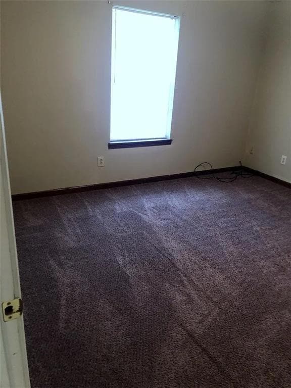 Spare room with carpet flooring and baseboards