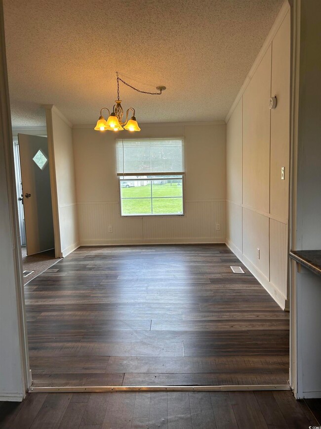 Unfurnished dining area with a textured ceiling, c