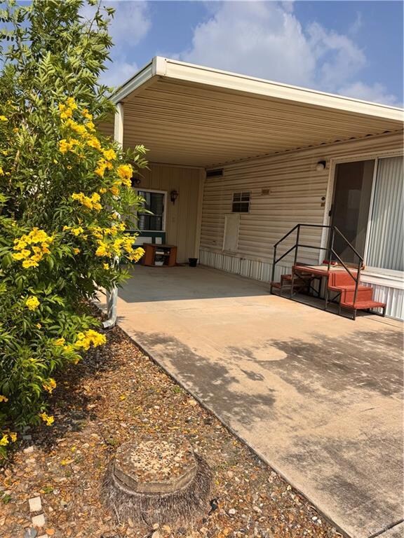 View of patio / terrace featuring a carport and concrete driveway