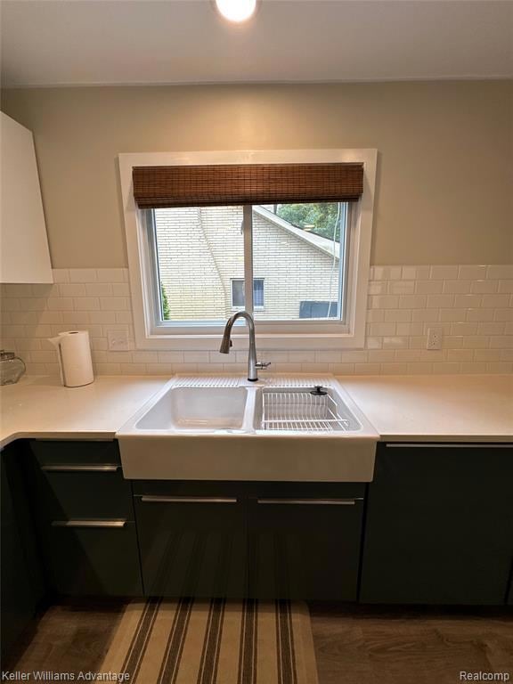Kitchen featuring decorative backsplash and dark wood finished floors