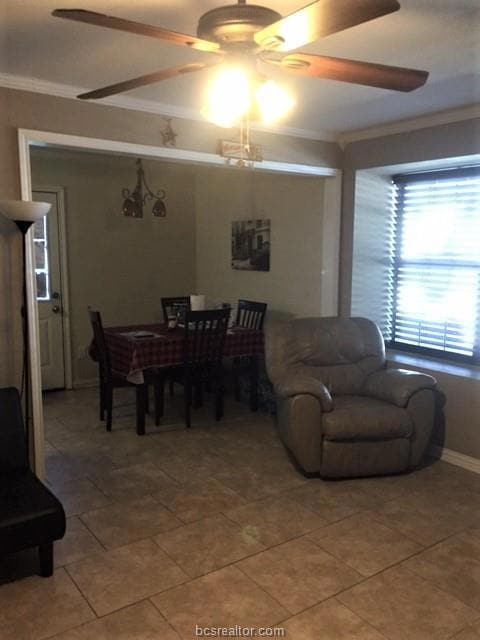 Dining area with crown molding, a ceiling fan, bas