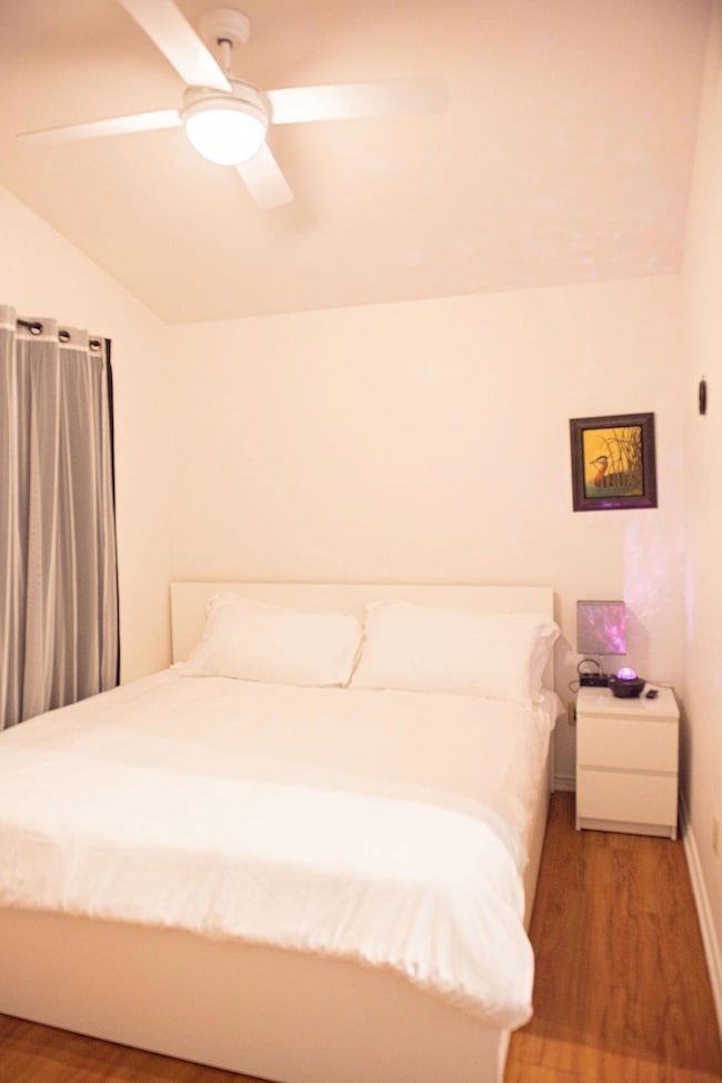 Bedroom with baseboards, light wood-style floors,