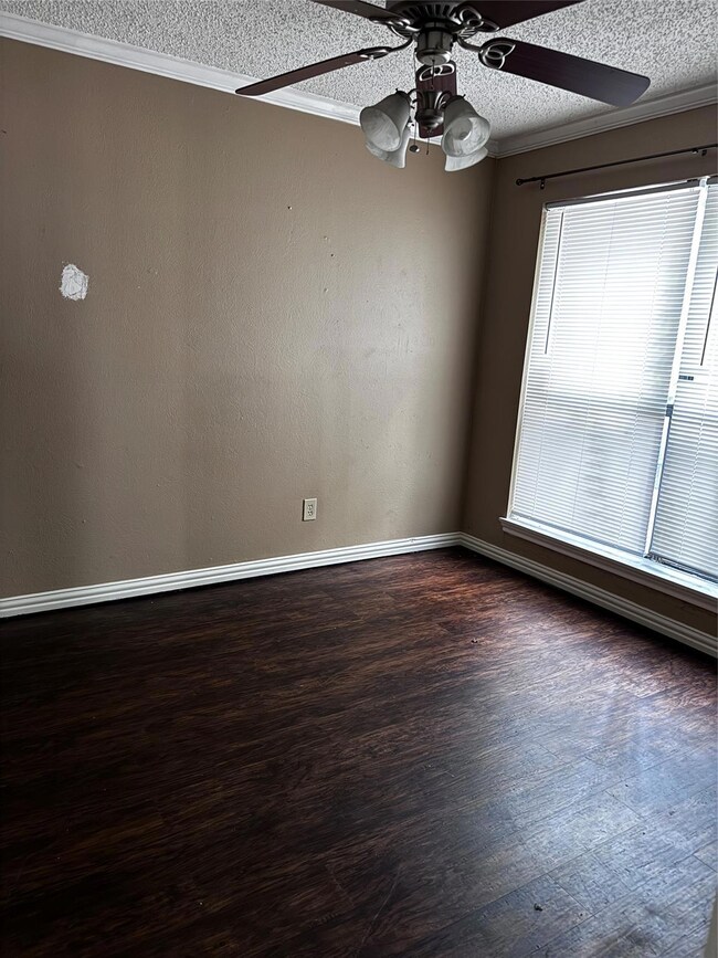 Unfurnished room featuring dark wood-type flooring