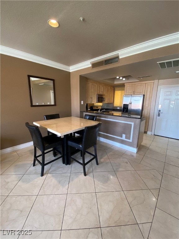 Dining area featuring crown molding, a textured ce