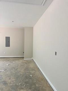 Empty room with electric panel and baseboards