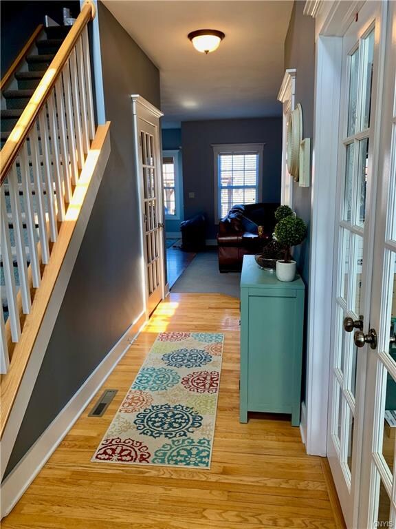 Hallway view from the front door. First floor office to the left and dining room to the right. Door to the left leads to finished basement. Straight ahead is the Family room.