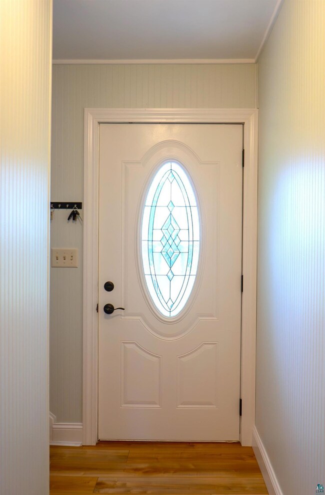 Foyer entrance with wood-type flooring