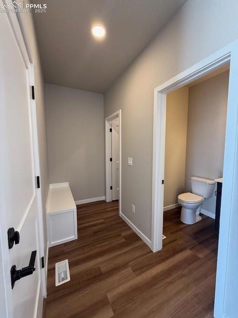 Hall featuring wood finished floors and baseboards