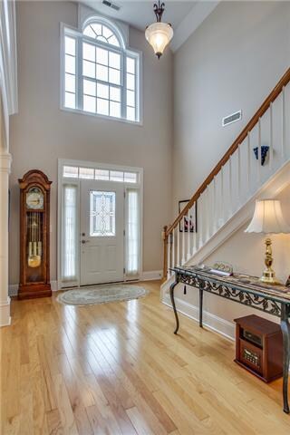 Two story foyer with tons of natural light streaming through adds an additional touch of elegance.