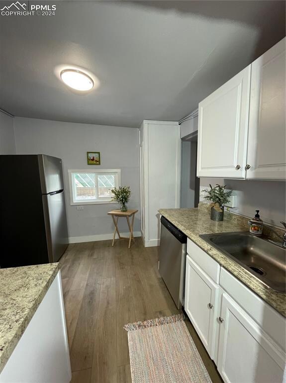 Kitchen with dishwasher, fridge, hardwood / wood-s