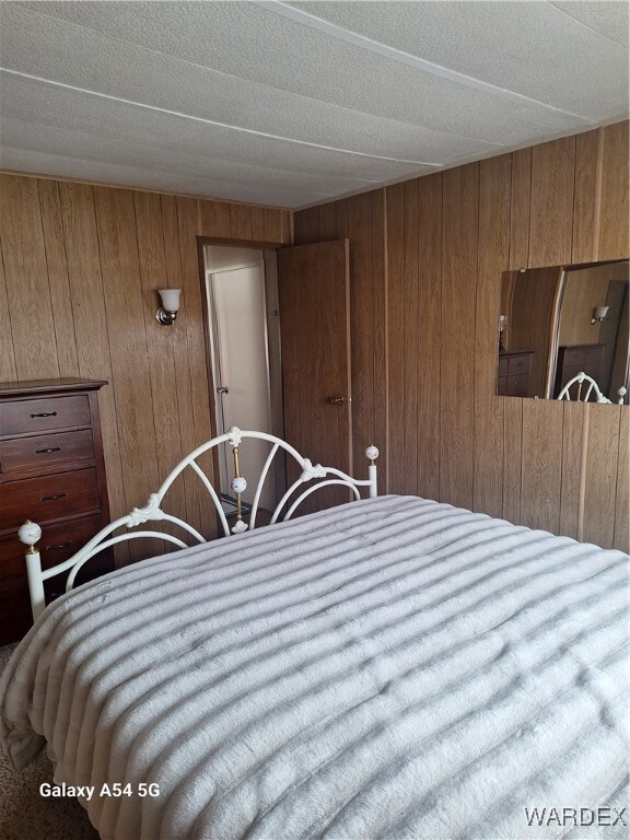 Bedroom featuring wooden walls