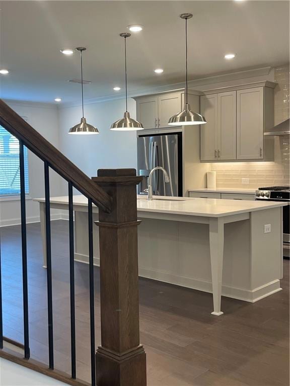 Kitchen featuring recessed lighting, pendant lighting, fridge, range, and tasteful backsplash