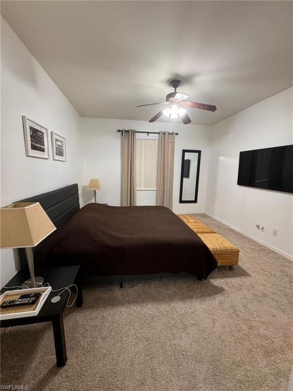 Carpeted bedroom featuring ceiling fan