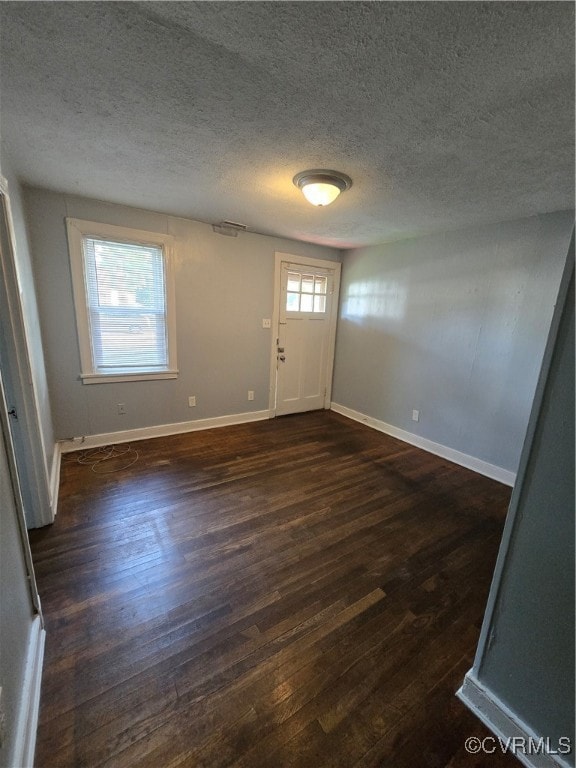 Entrance foyer featuring dark wood-style flooring