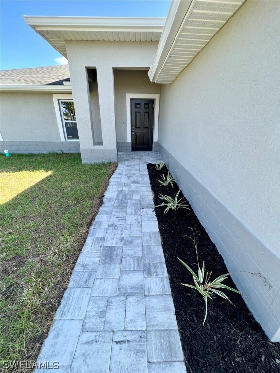 Front view with beautiful finishes and a brick pav